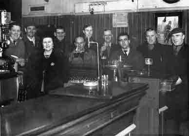 Mrs Margaret Clelland behind the bar at the end of the war